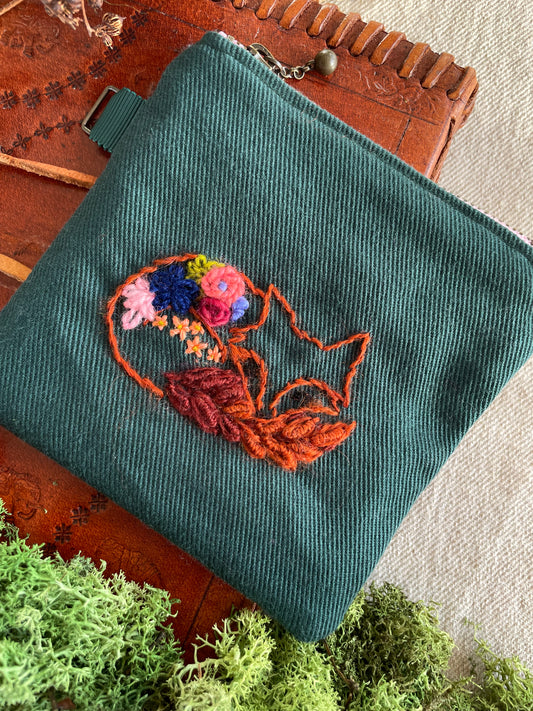 Max, the fox, sleeping with flower blooms