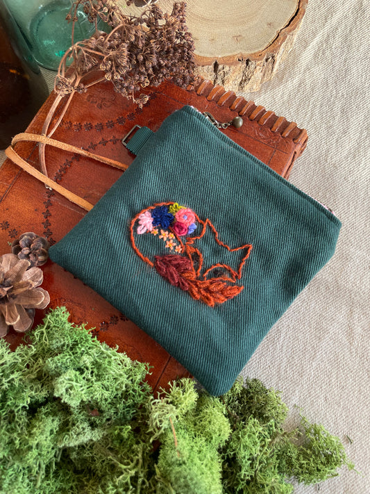 Max, the fox, sleeping with flower blooms